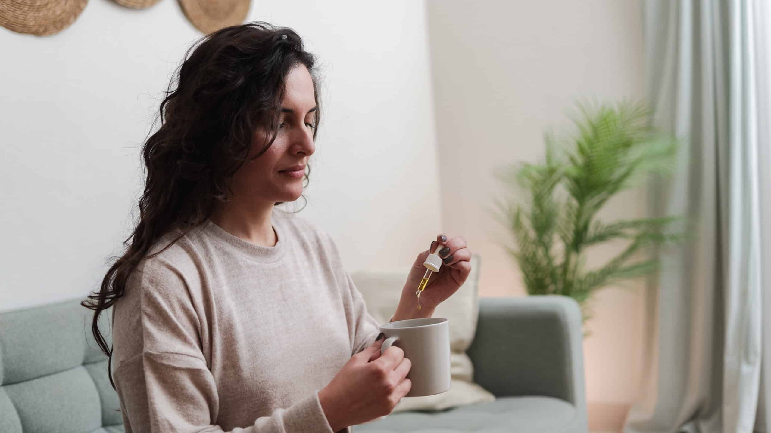 Woman taking cbd oil for anxiety treatment