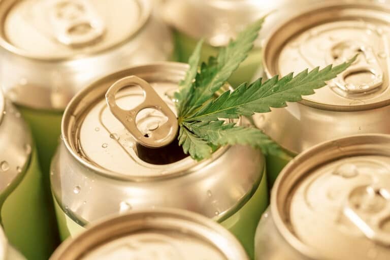 A collection of aluminum cans with a cannabis leaf.