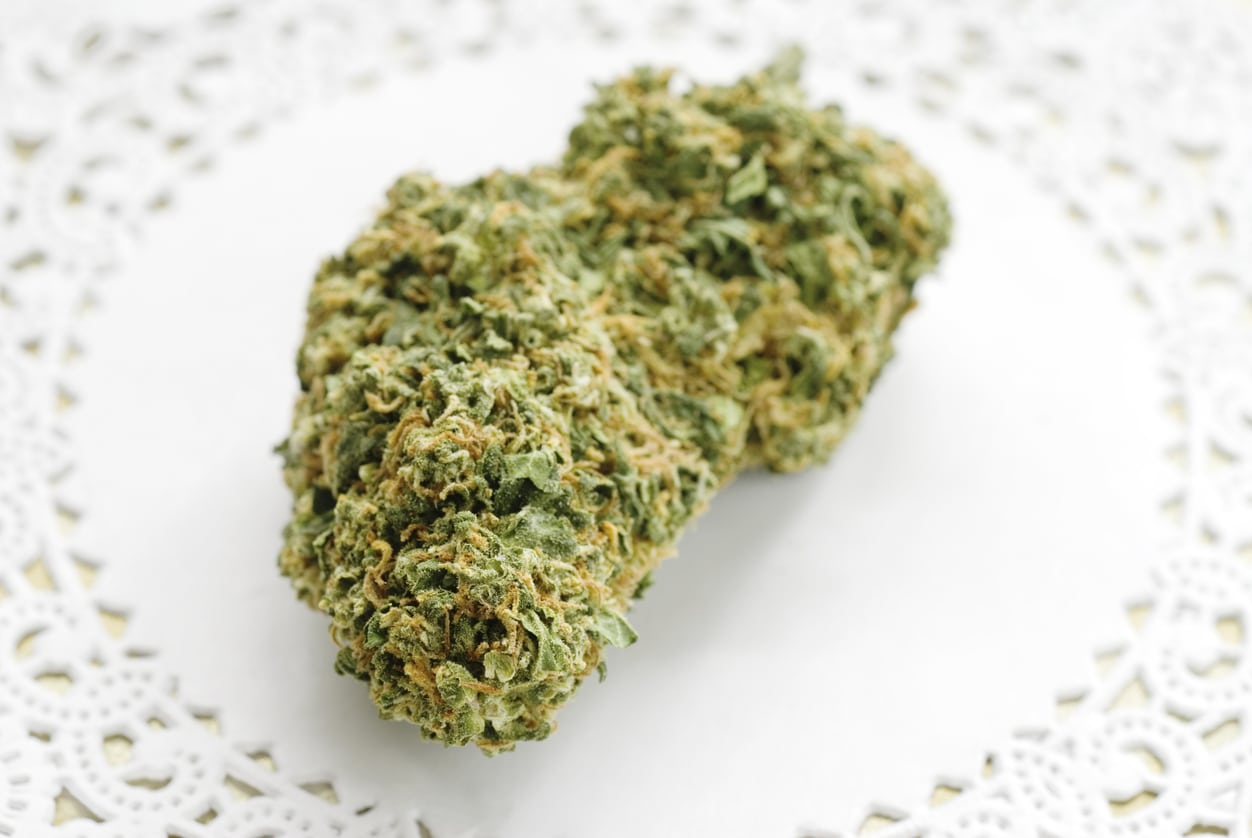 Marijuana bud up close on a white doily