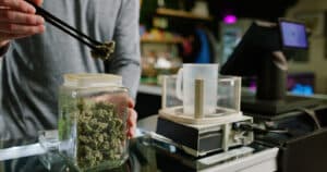 A budtender works inside of a retail cannabis shop in Oregon.